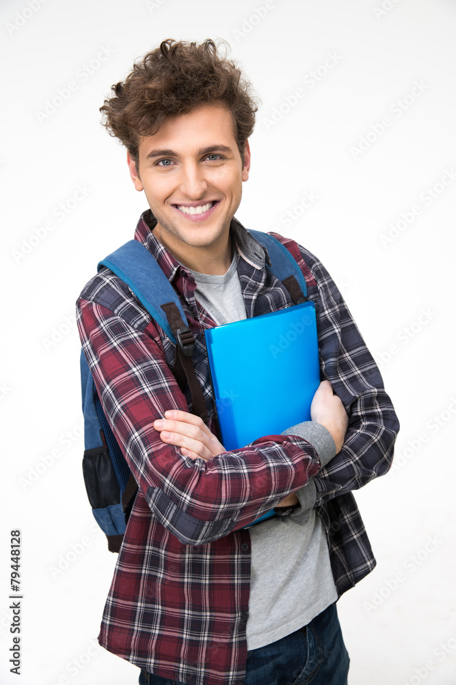 Smiling male student standing with folders over gray background Smiling male student standing with folders over gray background