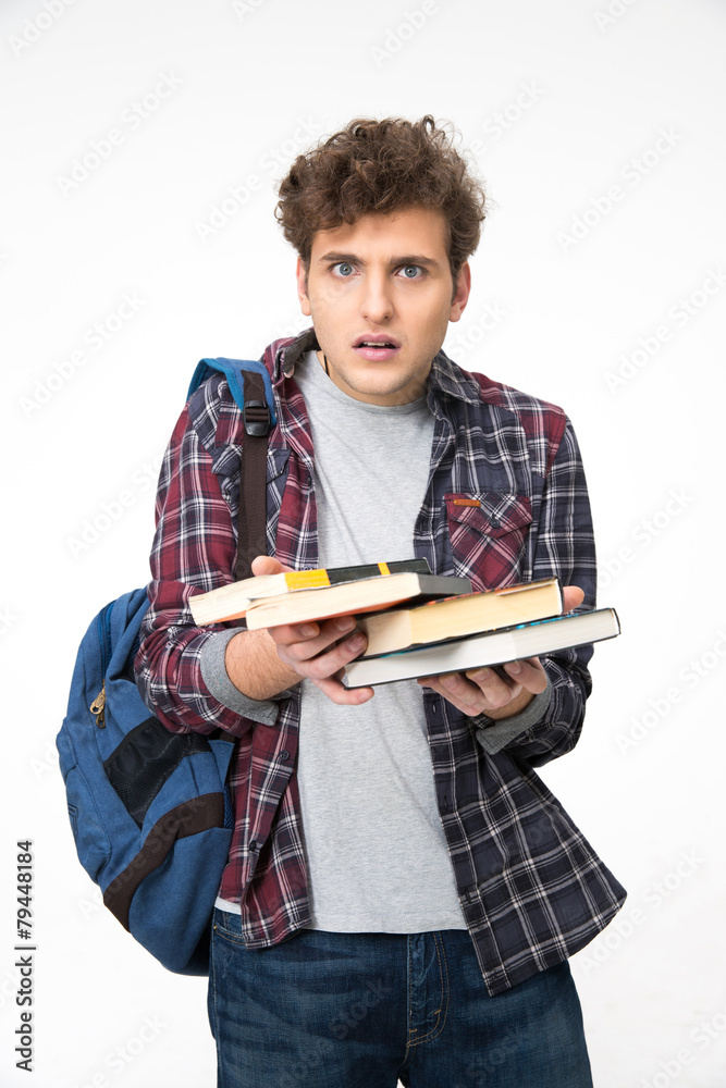 Surprised young man with books over gray background Surprised young man with books over gray background