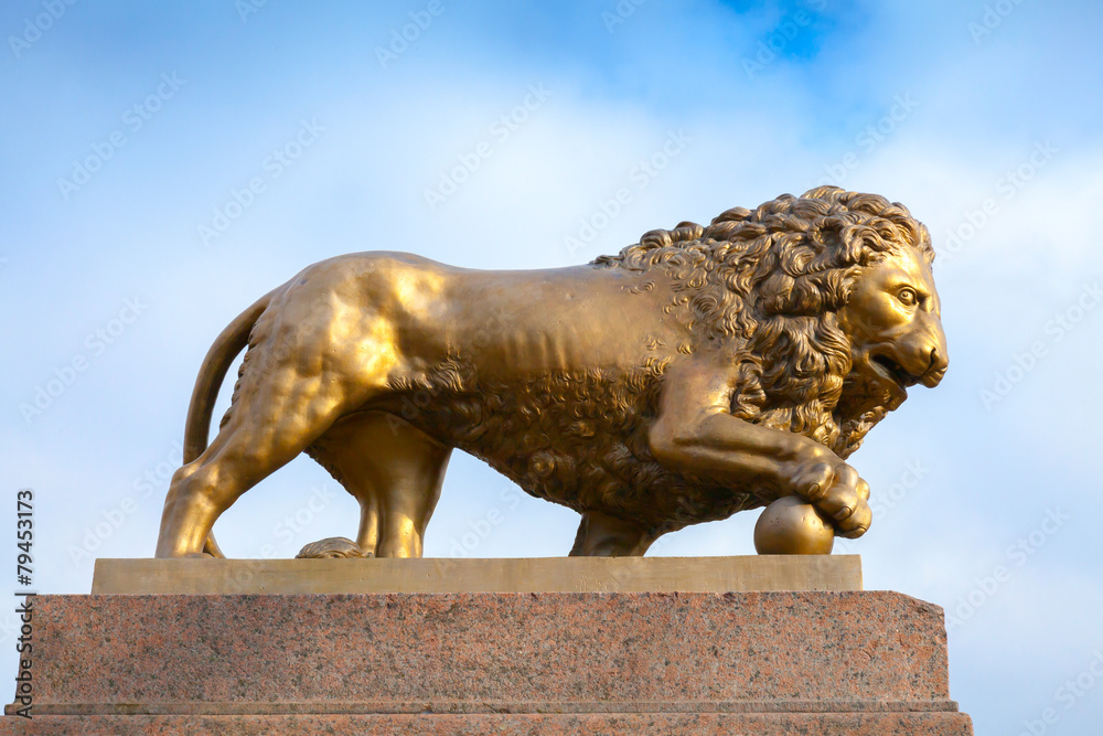 Bronze lion with ball, monument on stone base