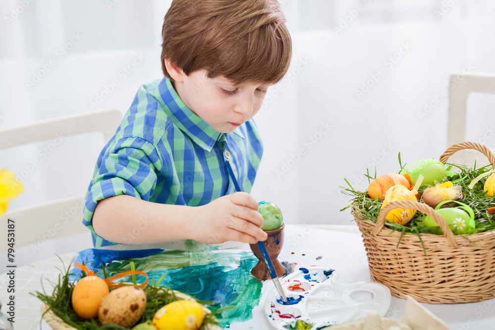 The day before Easter, beautiful child painting eggs for easter The day before Easter, beautiful child painting eggs for easter
