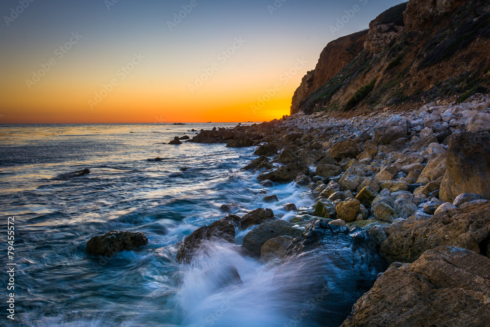 Waves crashing on rocks at Pelican Cove at sunset, in Rancho Pal Waves crashing on rocks at Pelican Cove at sunset, in Rancho Pal