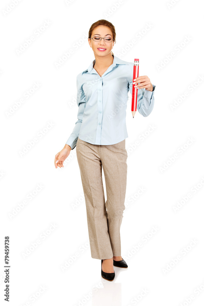 Businesswoman holding big pencil. Businesswoman holding big pencil.