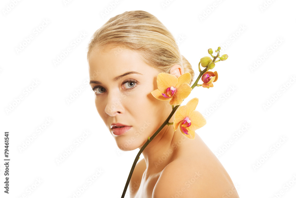 Beautiful spa woman with orange orchid