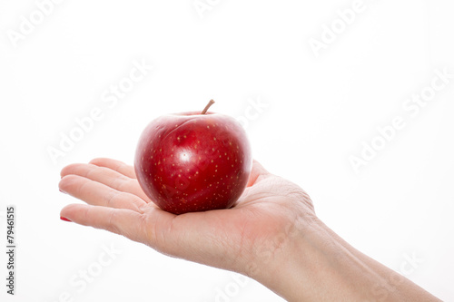 Woman's hand with red apple on white background