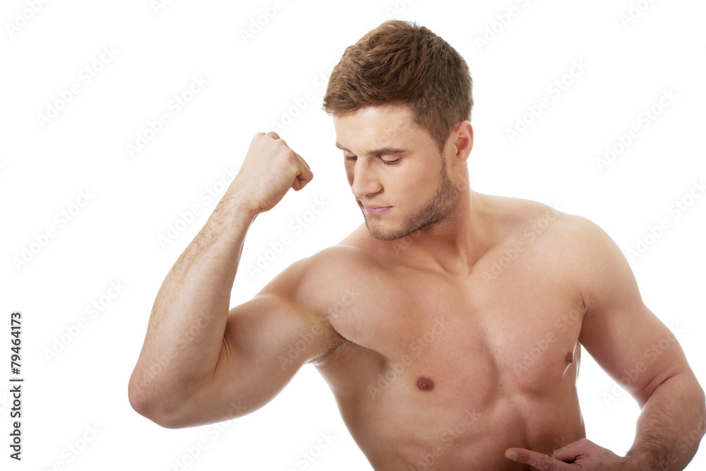 Young athletic man showing his muscles.