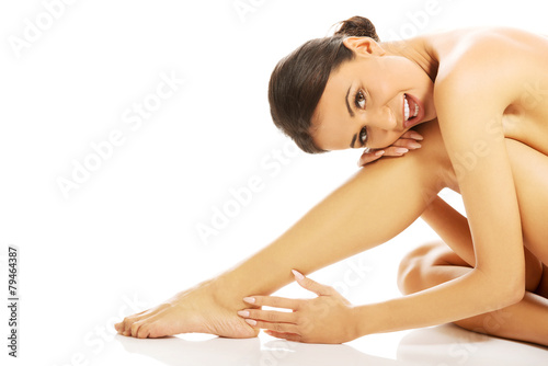 Slim spa woman sitting curled up