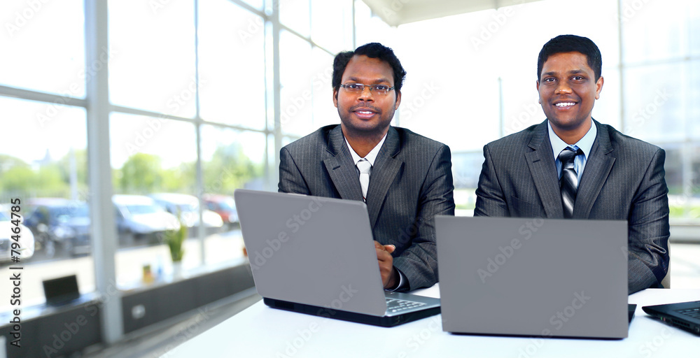 Interracial business team working at laptop
