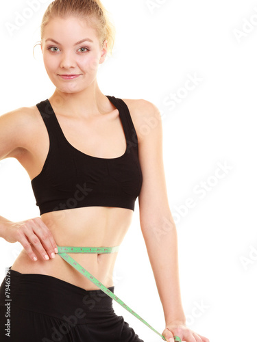 diet. slim blonde girl with measure tape measuring waist