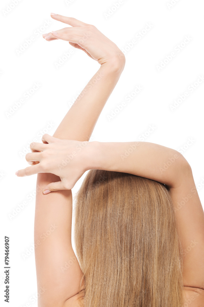 Naklejka premium Back view of nude woman holding arms above head