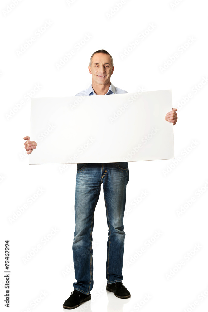 Handsome man holding an empty banner Handsome man holding an empty banner