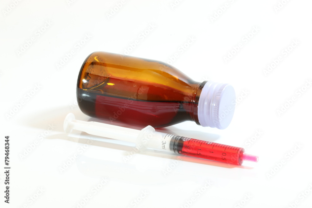 Bottle pouring Medicine Syrup in Spoon Bottle pouring Medicine Syrup in Spoon
