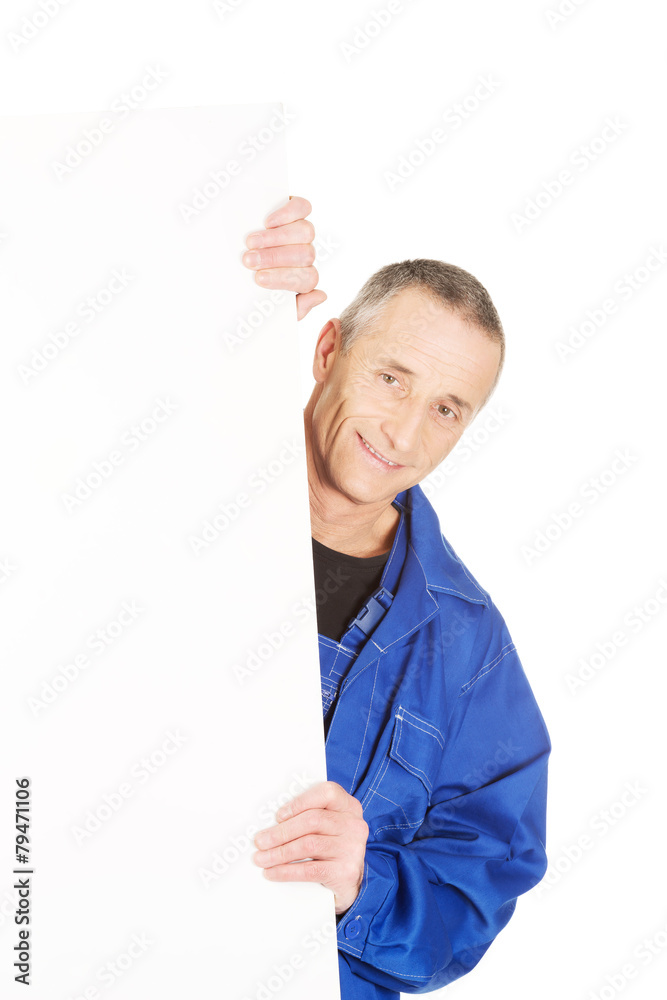 Happy worker presenting empty banner Happy worker presenting empty banner