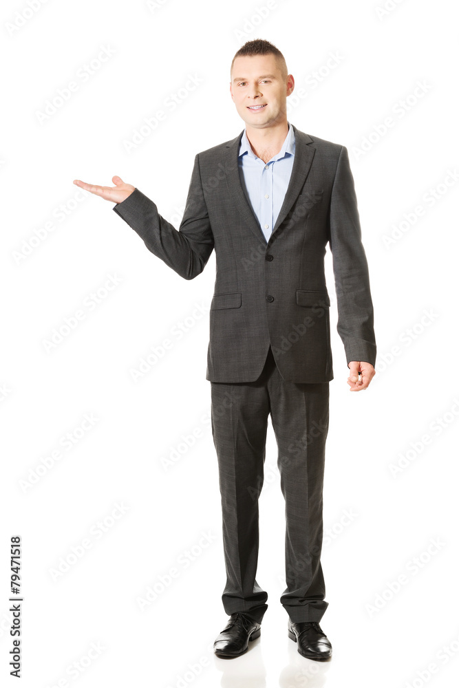 Smiling businessman holding copyspace Smiling businessman holding copyspace