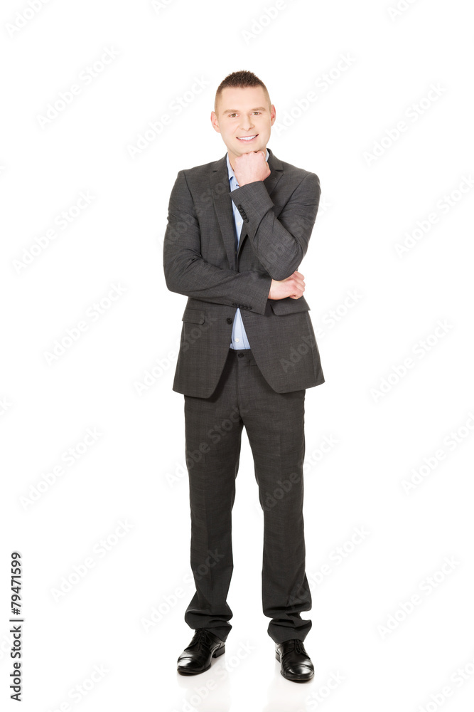 Businessman with hand under chin Businessman with hand under chin