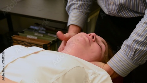 A woman receiving a neck adjustment