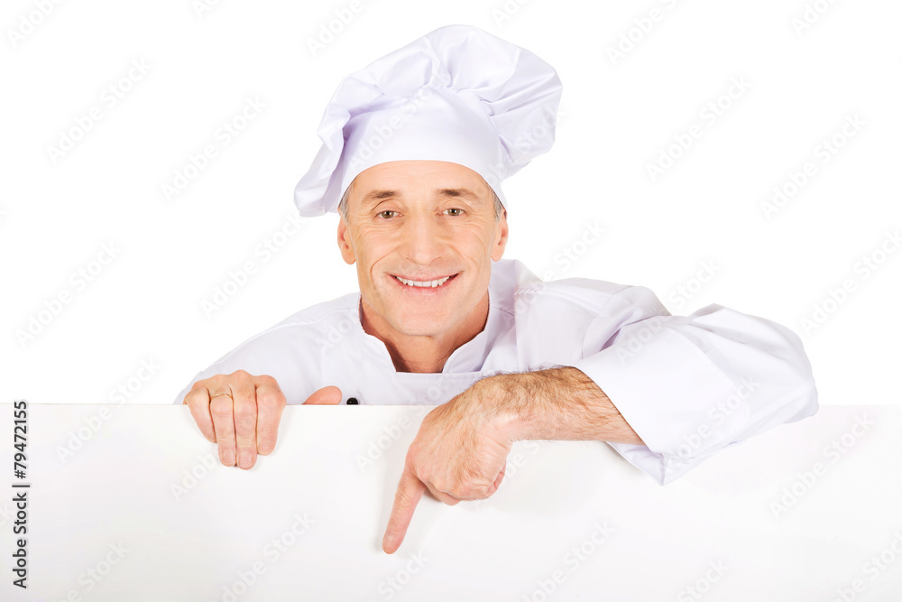 Chef in white uniform holding empty banner Chef in white uniform holding empty banner