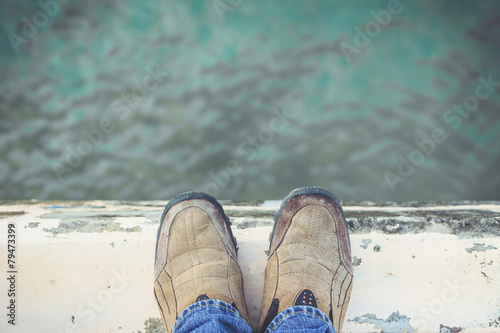 Feet Standing on Cement Edge