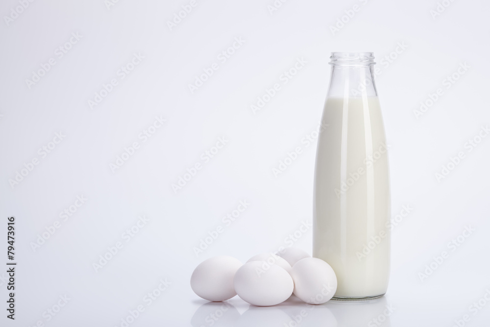 Milk and eggs on white background. Milk and eggs on white background.