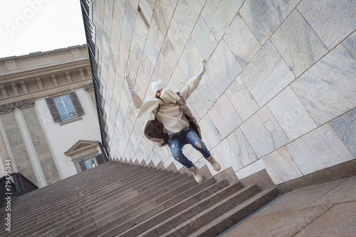 Beautiful young woman jumping down stairs © tinx