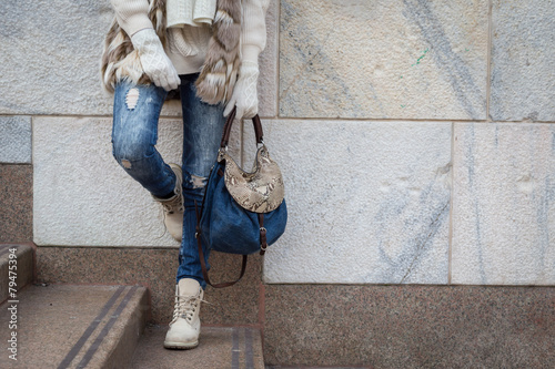 Detail of a young woman posing in the city streets