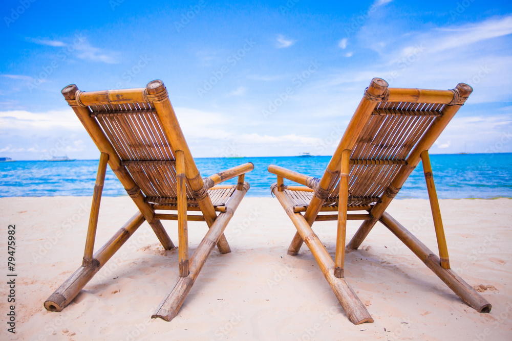 Beach chairs on perfect tropical white sand beach