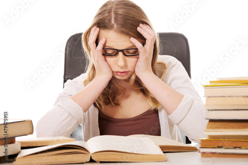 Young woman with a books pile