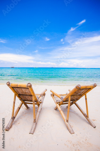 Beach chairs on perfect tropical white sand beach © travnikovstudio
