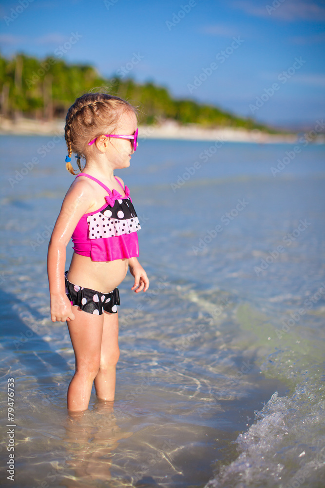 Happy little girl having fun at shallow water Happy little girl having fun at shallow water