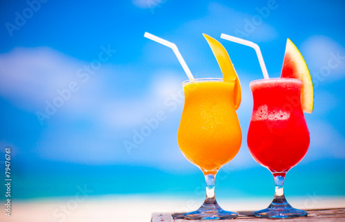 Two tasty alcoholic cocktails on background of turquoise sea