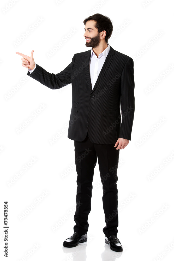 Happy businessman points to the left. Happy businessman points to the left.