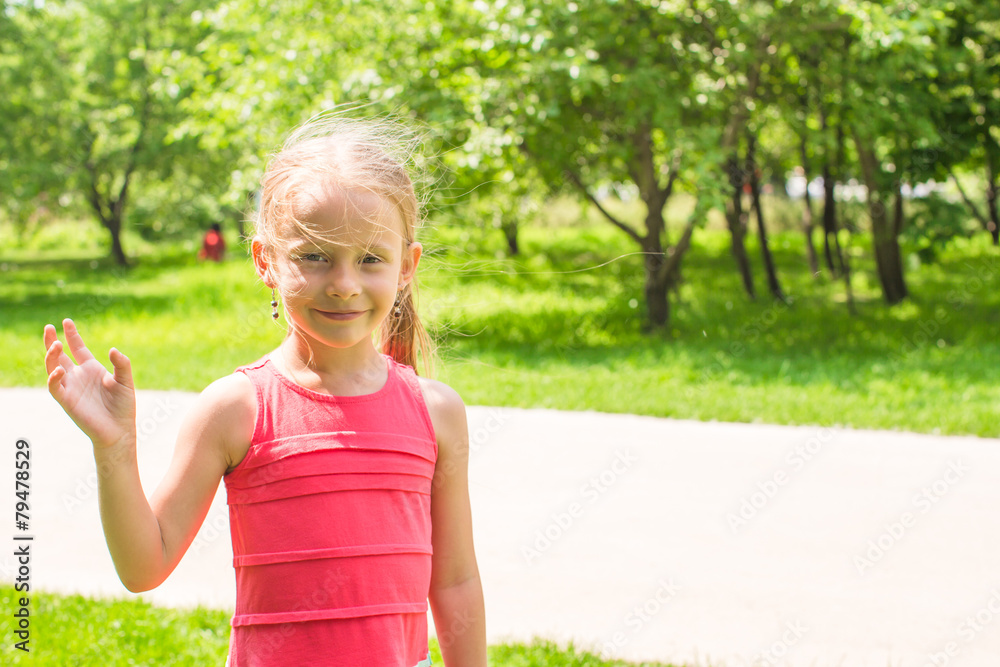 Little adorable girl with flowers in the garden