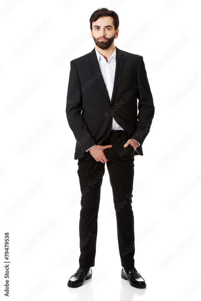 Young businessman feeling pain in his crotch. Young businessman feeling pain in his crotch.