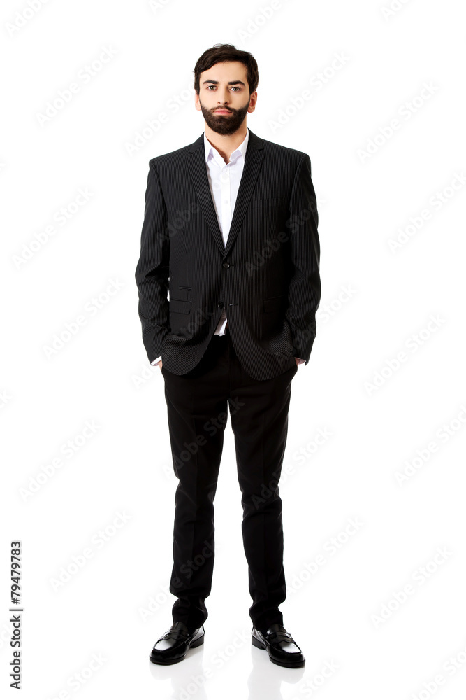 Smiling businessman with hands in pockets. Smiling businessman with hands in pockets.