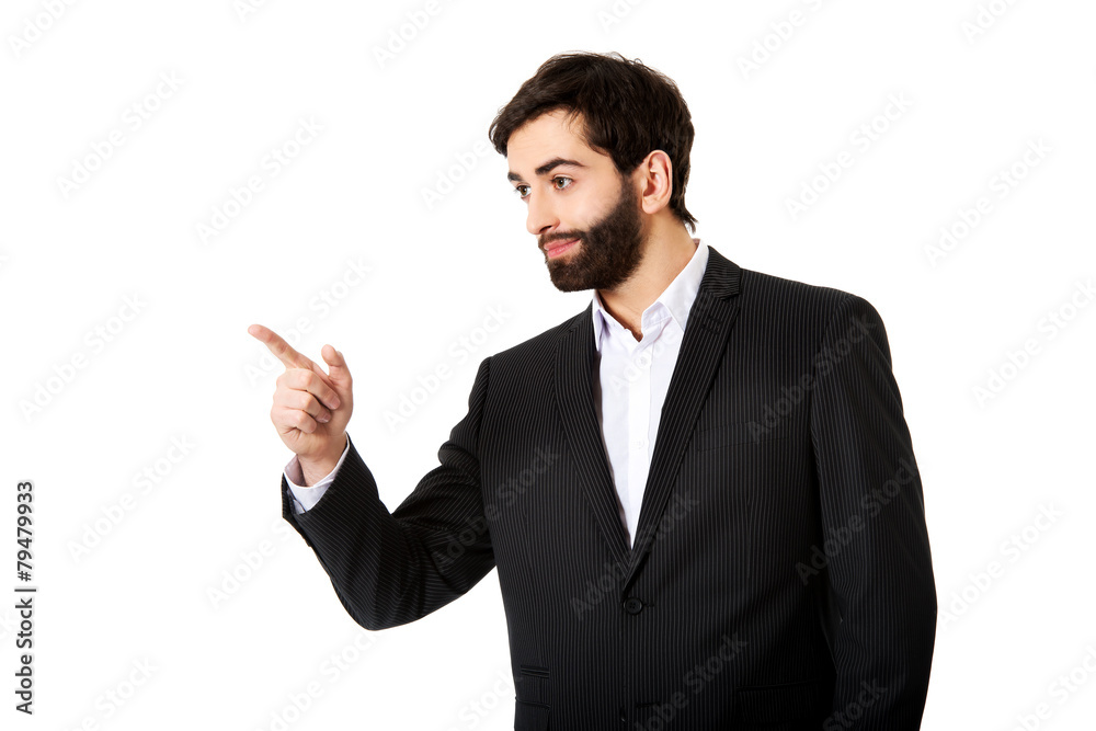 Happy businessman points his finger. Happy businessman points his finger.