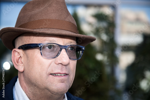 Hairless man with glasses smiling with white background © Eduardo Lopez