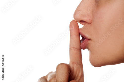 finger on the lips. sign for silence photo