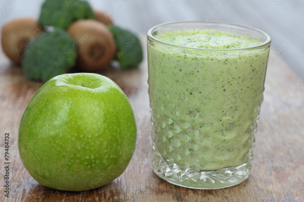 Glass full of apple, broccoli and kiwi milk smoothie. Glass full of apple, broccoli and kiwi milk smoothie.