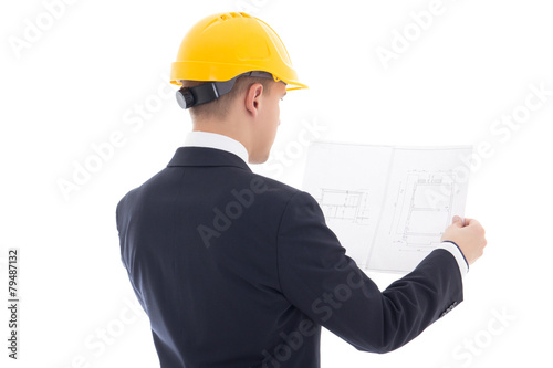 back view of business man in yellow builder's helmet with bluepr