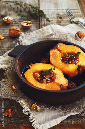 Quince baked with honey, walnut and thyme in clay dish