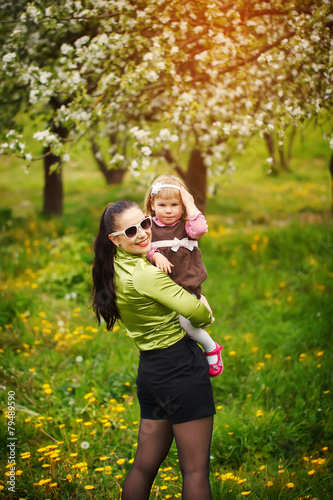 lovely mother and child together smiling outdoors in sunny warm