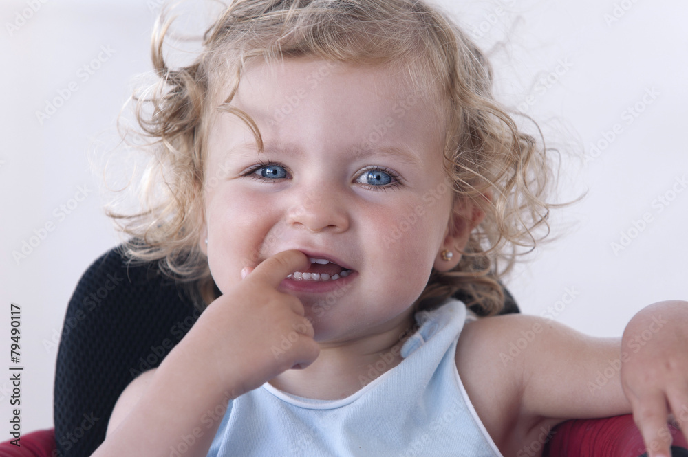 Closeup of a baby's face with a finger in her mouth Closeup of a baby's face with a finger in her mouth