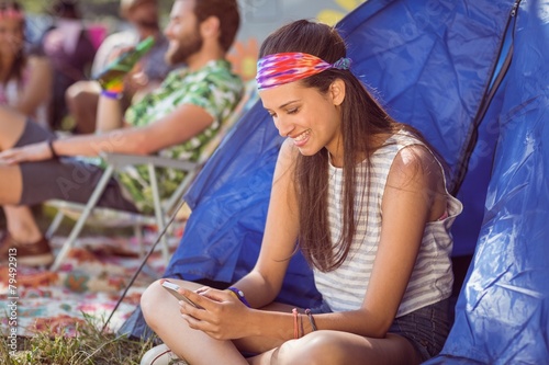 Carefree hipster sending text message