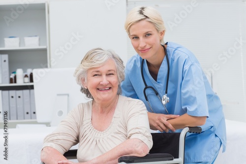 Nurse leaning on senior patients wheelchair at clinic © WavebreakMediaMicro