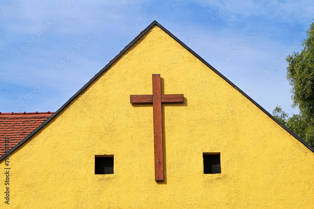Wooden cross on the wall of the church Wooden cross on the wall of the church