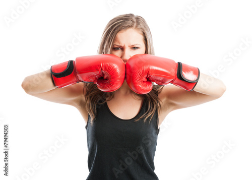 Mad female boxer touching red boxing gloves together