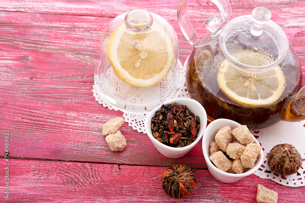 drink in glass teapot on wooden background