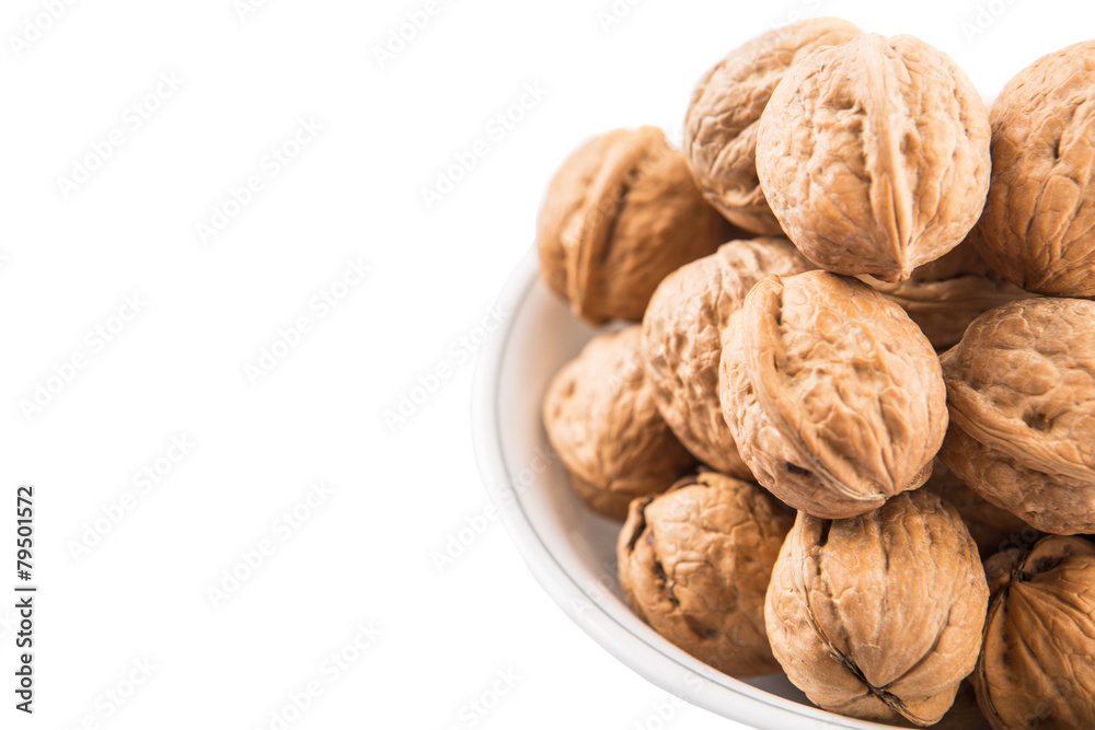 Walnuts in a white bowl over white background Walnuts in a white bowl over white background