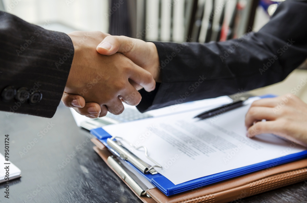 Businesswoman shaking hand for a deal Businesswoman shaking hand for a deal