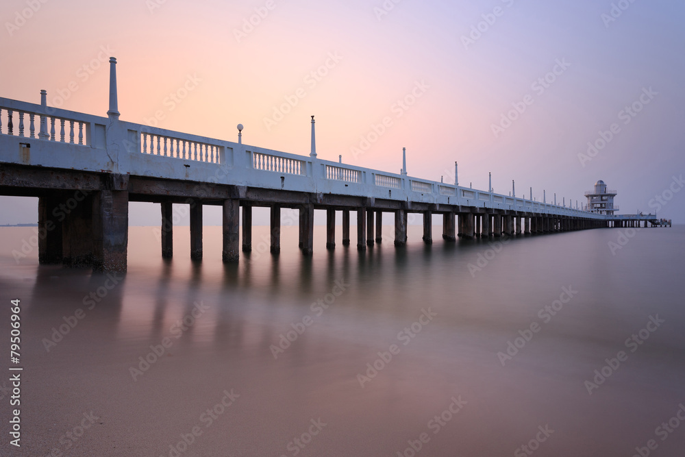 The long concrete bridge over the sea with a beautiful sunrise ,