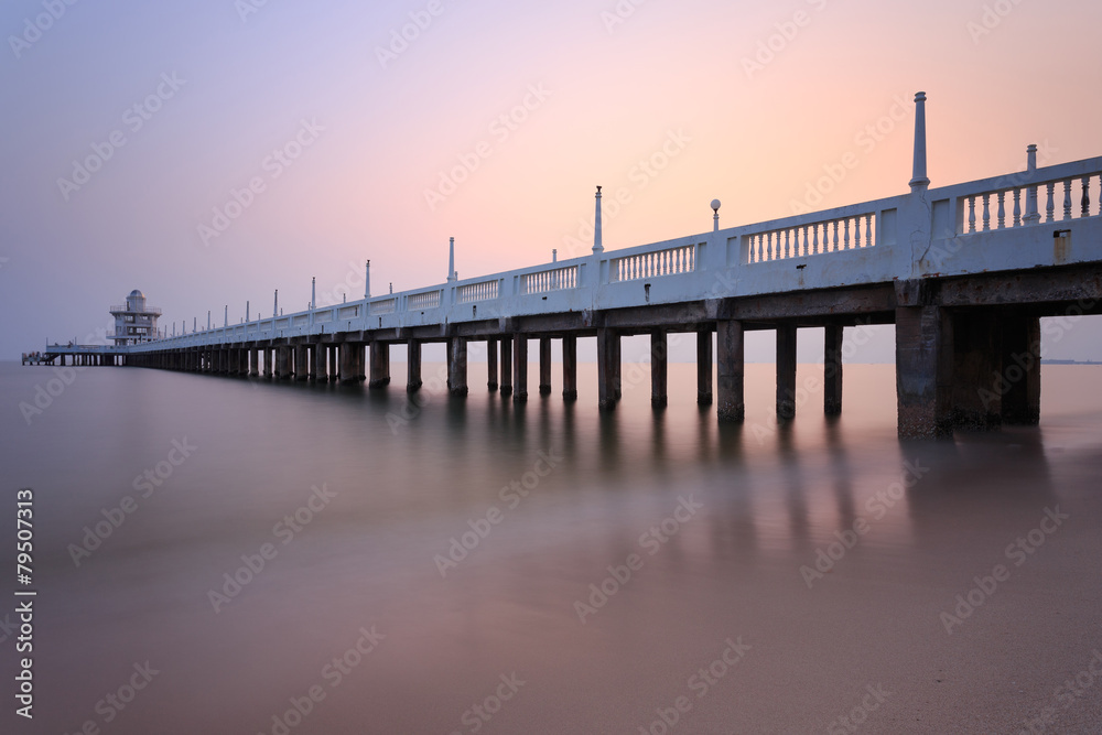 The long concrete bridge over the sea with a beautiful sunrise ,